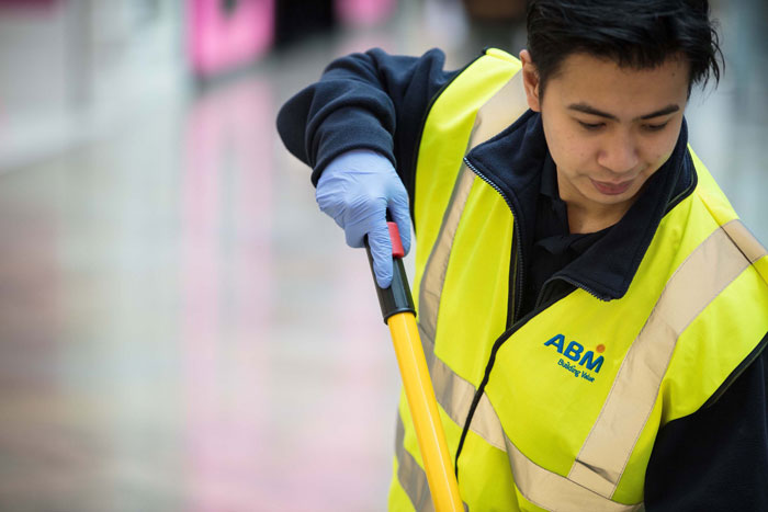 ABM UK worker in yellow high-vis vest